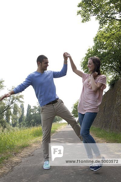 Enthusiastic young couple on a path