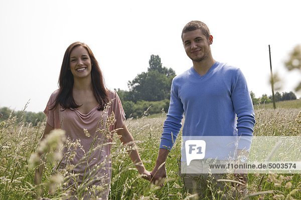 Happy young couple in field
