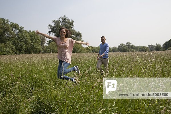 Enthusiastic young couple in field