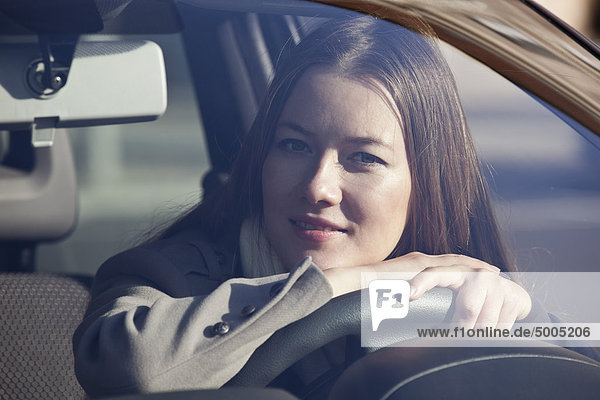 Woman looking out car window