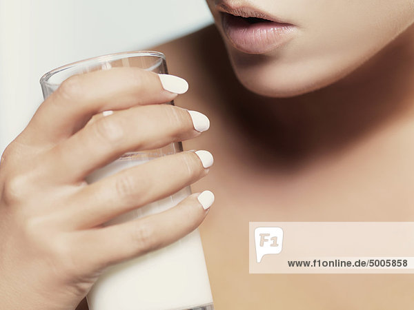 Eine Frau mit einem Glas Milch  Nahaufnahme von Lippen und Hand  Mund.