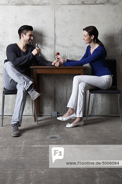 A couple enjoying a glass of wine in a restaurant
