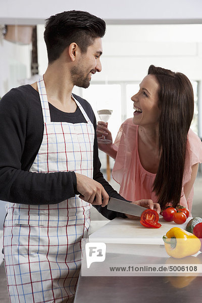 A young couple having fun while cooking