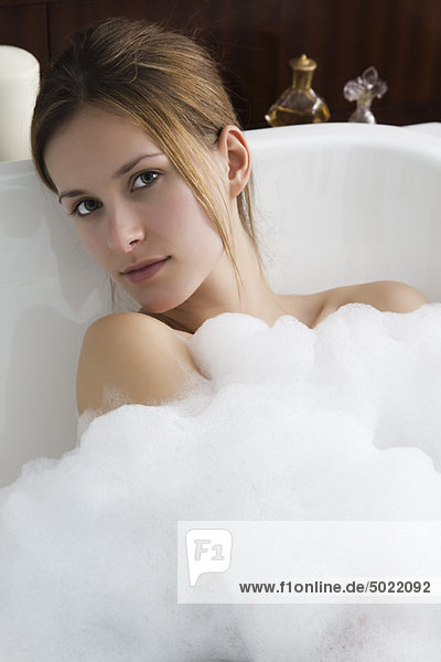 Woman relaxing in bubble bath  portrait