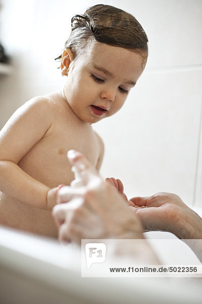 Toddler boy taking a bath