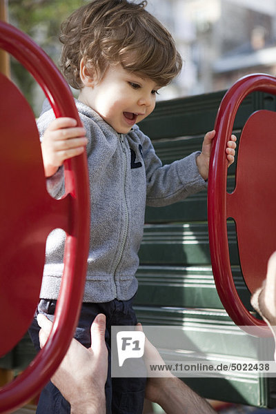 Toddler boy playing on playground