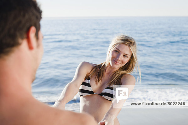 Couple holding hands on beach