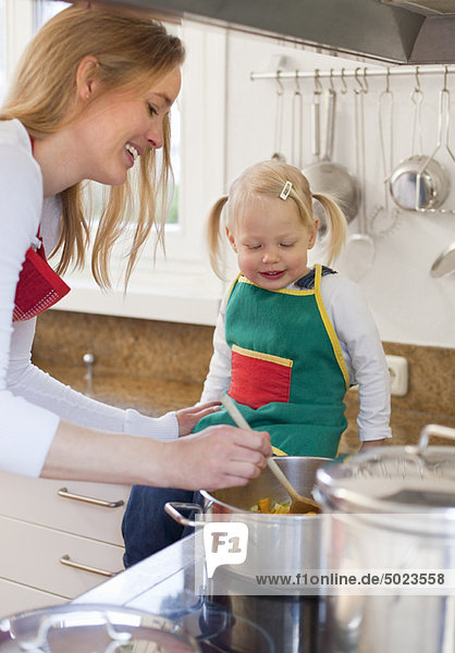 Mother and daughter cooking together