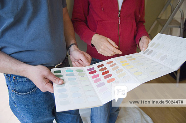 Couple choosing paint colors in new home