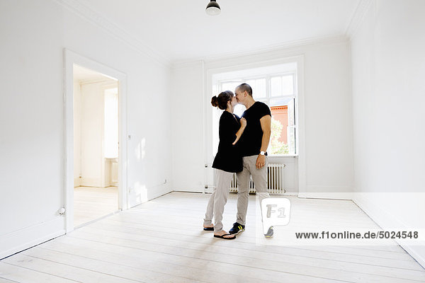 Couple kissing in new home