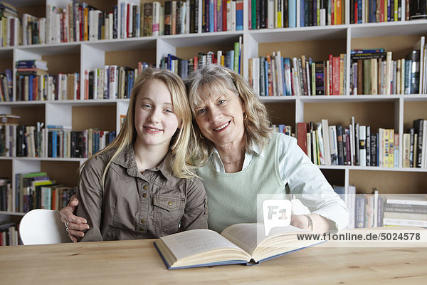 Woman and granddaughter reading together