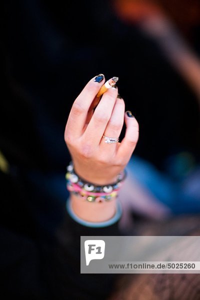 Hand of teenage girl holding cigarette