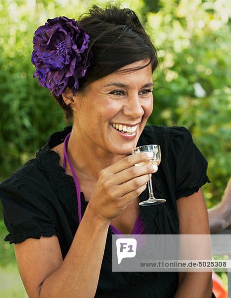 Woman holding glass of wine  smiling  close-up