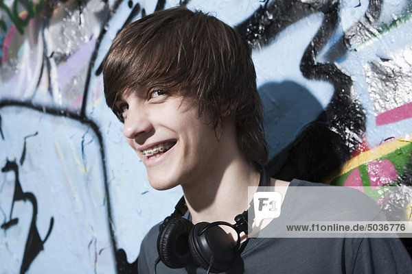 Teenage boy with headphones  smiling