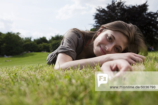 Teenage girl lying on grass