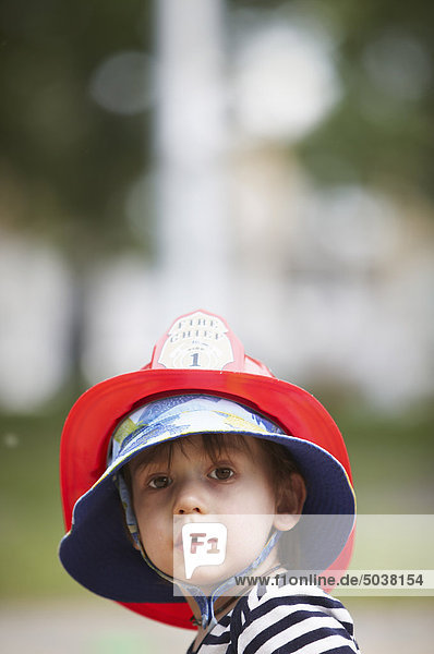Portrait of little boy in fireman hat  Montreal  Quebec  Canada