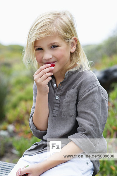 Portrait of a girl eating fruit