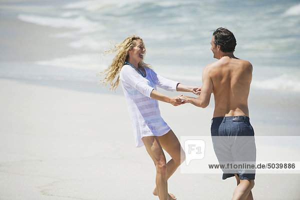 Couple playing on the beach