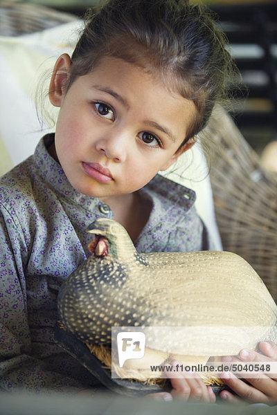 Portrait of a little girl holding model of turkey