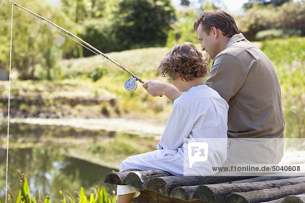 Father and son fishing in a lake
