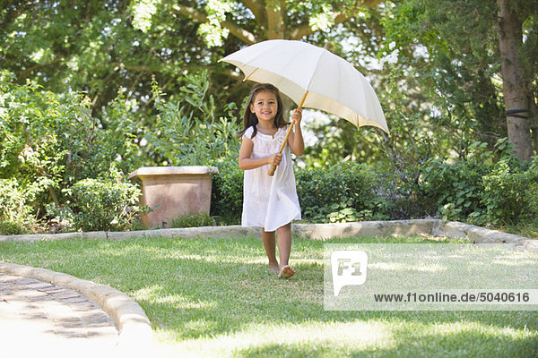 Cute little girl holding an umbrella