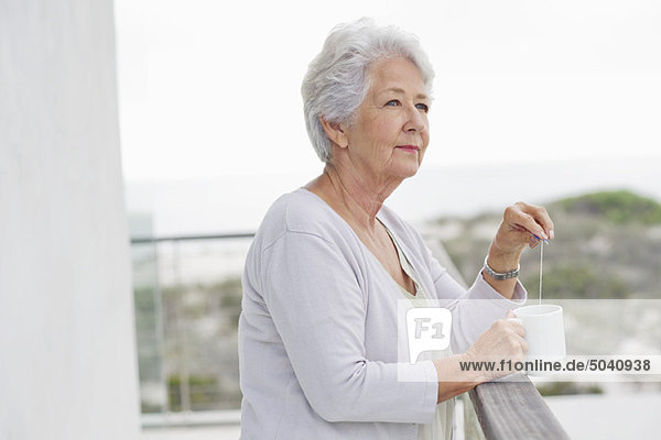 Senior woman holding a coffee cup