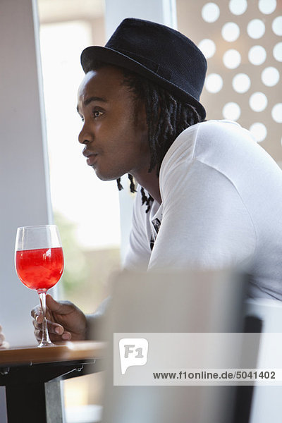 Junger Mann bei Rotwein in einer Bar