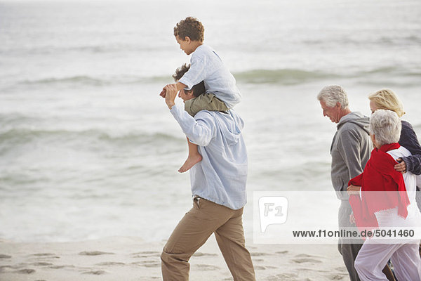 Multi-generation family walking on the beach