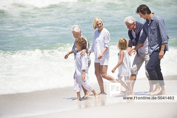 Multi-generation family walking on the beach