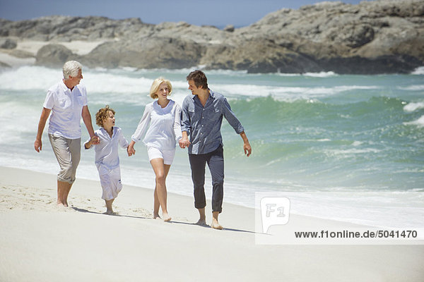 Multi generation family walking on the beach