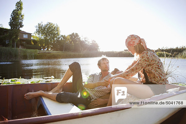 Young couple romancing in the boat