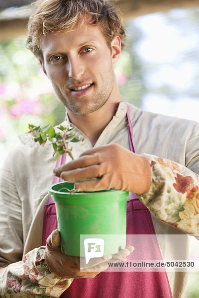 Portrait of a man gardening and smiling