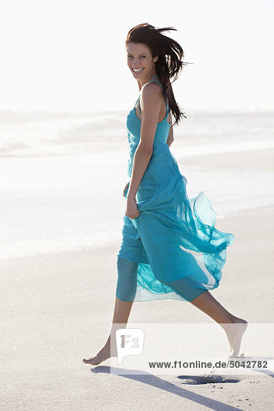 Portrait of a young woman walking on beach