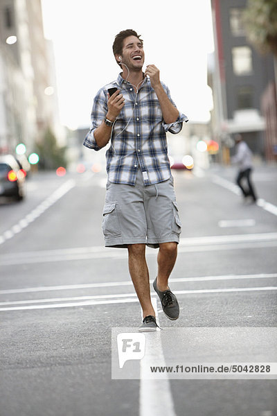 Man talking on a mobile phone while walking on the road