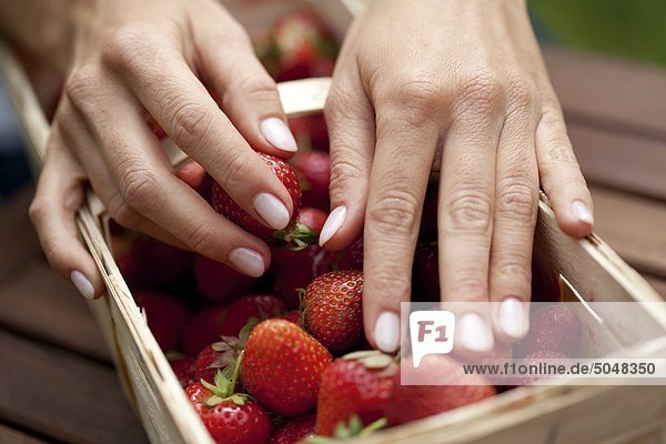 Hand an Erdbeeren