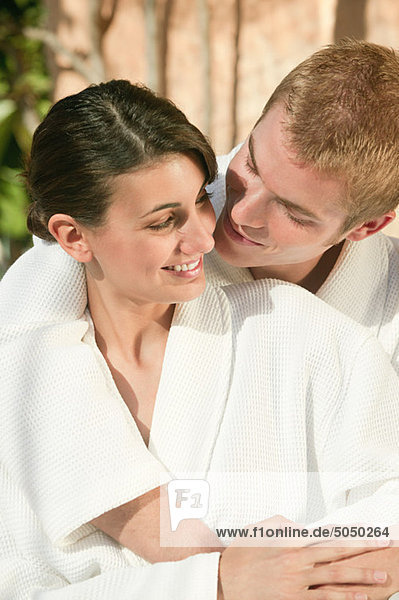 Young couple in bathrobes