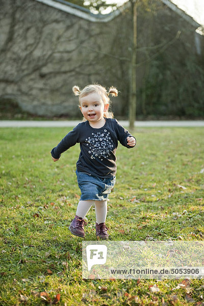 Toddler girl playing outdoors