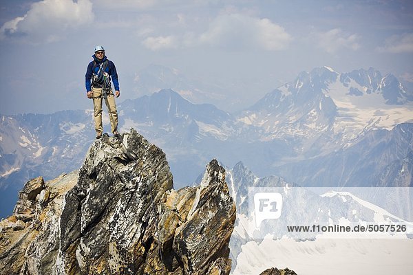 A young man mountain climbing the classic north west ridge of Mt. Sir Donald  Glacier National Park  British Columbia  Canada