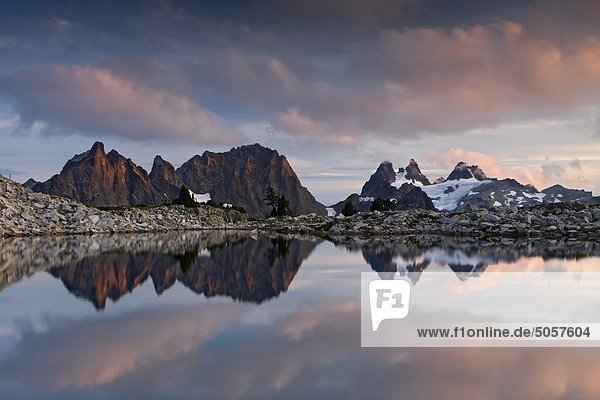 Sunset at Lower Tank Lake  Bears Breast  Chimney Rock and Overcoat Peak in the distance  Alpine Lakes Wilderness  Washington State  United States of America