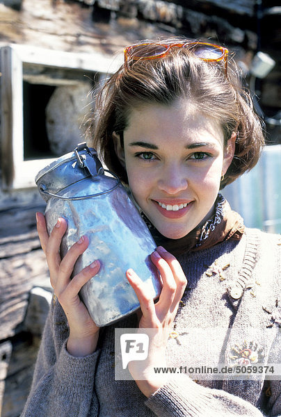 Woman holding old milk container