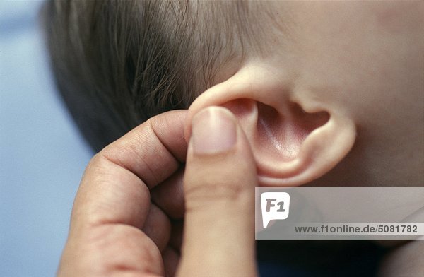 Finger massieren Babys Ohr