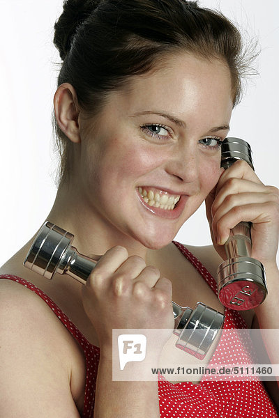 Close up of a young woman with dumbbells