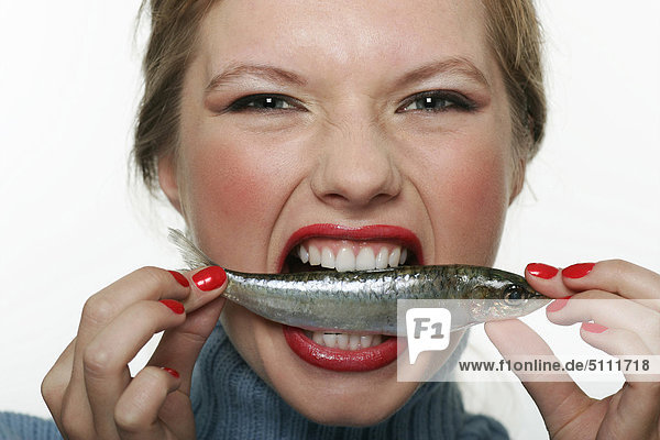 Woman biting raw fish