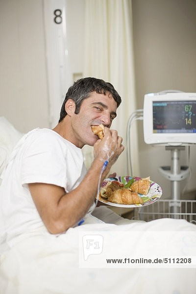 Hospital patient eating in bed