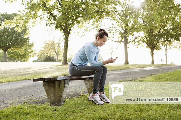 Runner using cell phone in park