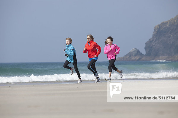 Family running together on beach