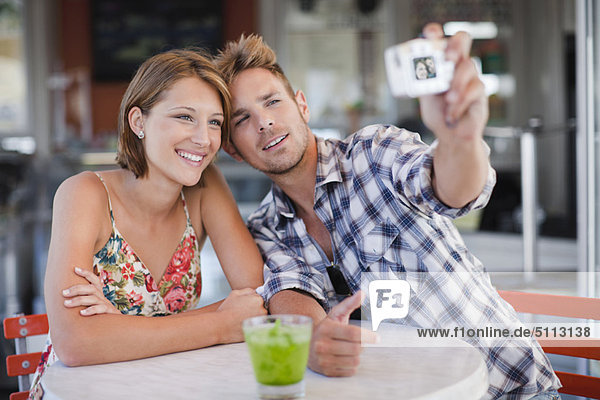 Couple taking pictures of themselves