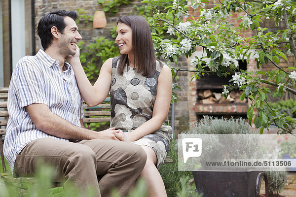 Smiling couple sitting together outdoors