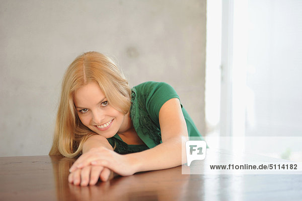 Smiling woman laying on table