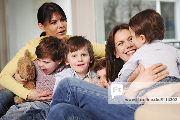 Family sitting on sofa together